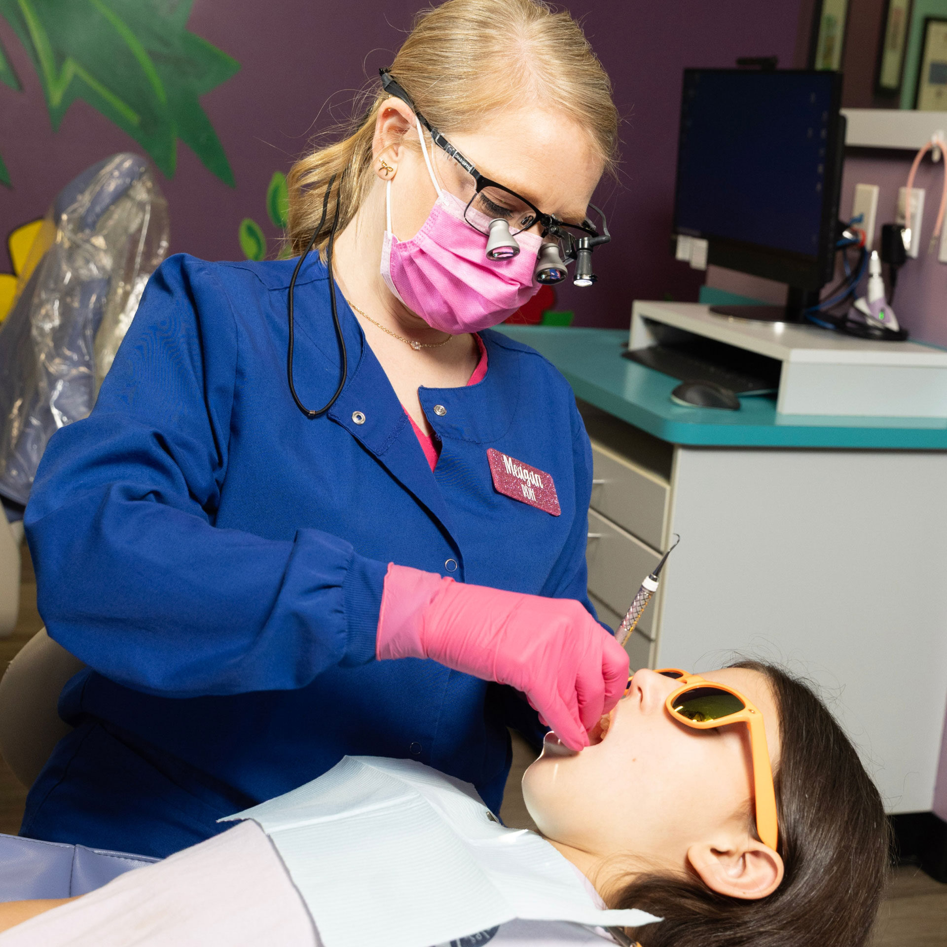 dental assistant performing exam on patient